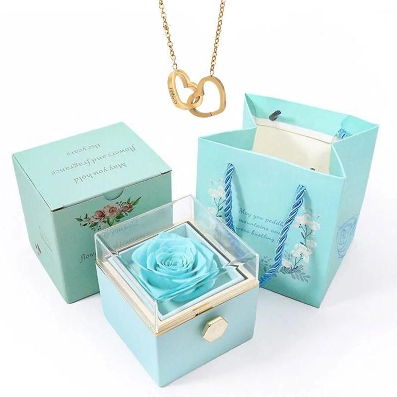 Elegante caja de acero inoxidable con forma de rosa giratoria y collar con corazón grabado