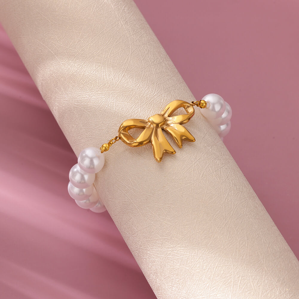 Pulsera de lazo dorado con perlas de imitación