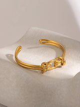 Offenes Manschettenarmband aus goldenem Edelstahl mit geometrischem Muster