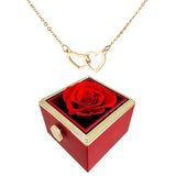 Elegante caja de acero inoxidable con forma de rosa giratoria y collar con corazón grabado