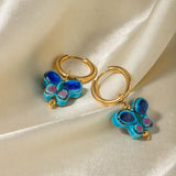 Aretes de cerámica con forma de mariposa y flor azul de acero inoxidable chapado en oro de 18 quilates