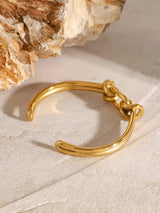 Offenes Manschettenarmband aus goldenem Edelstahl mit geometrischem Muster