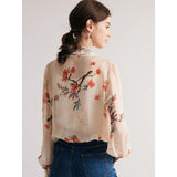 Blusa elegante con cuello de lazo en mezcla de seda floral